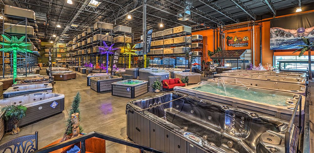 Swim spas and hot tubs in a large warehouse showroom